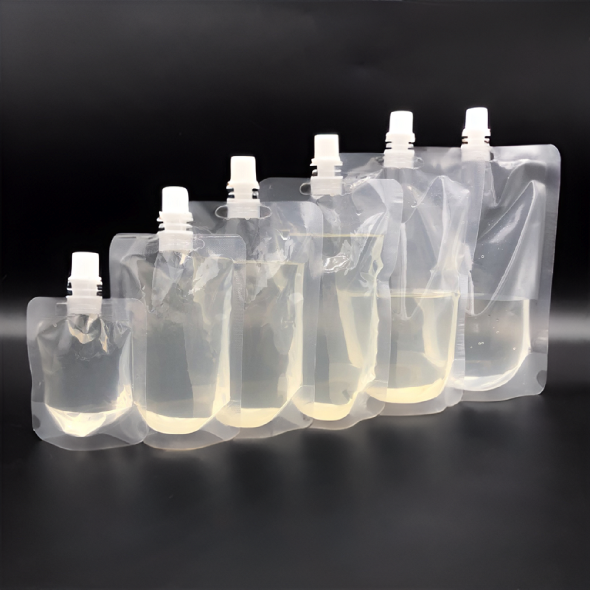Bulk pack of stand-up clear poly pouches with spouts for food, drinks, or cosmetics